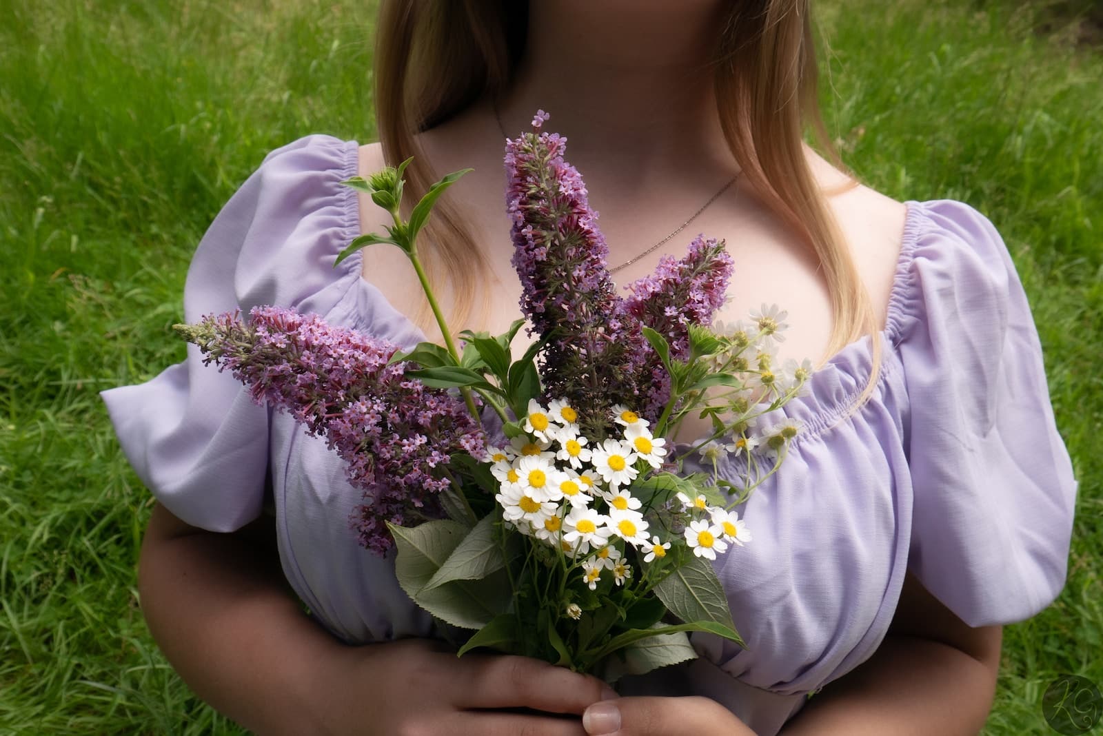 a woman in a dress holding a bouquet of flowers